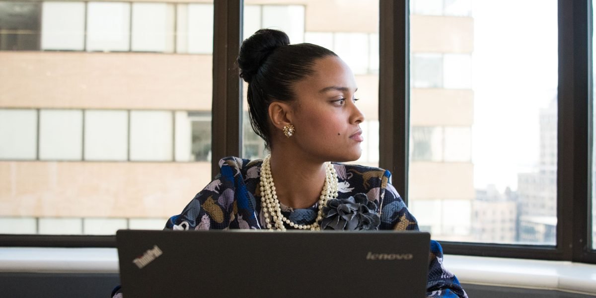 An individual thoughtfully considering their professional journey and impact.