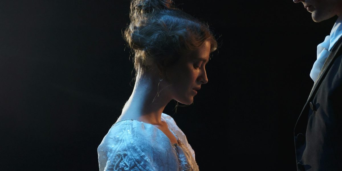 An actress on stage, emotionally accepting a prestigious award for her performance.