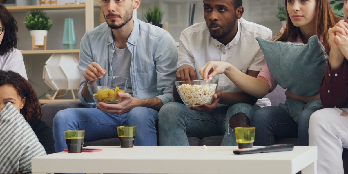 Friends gather to enjoy a captivating movie night, highlighting the shared experience of watching great films.