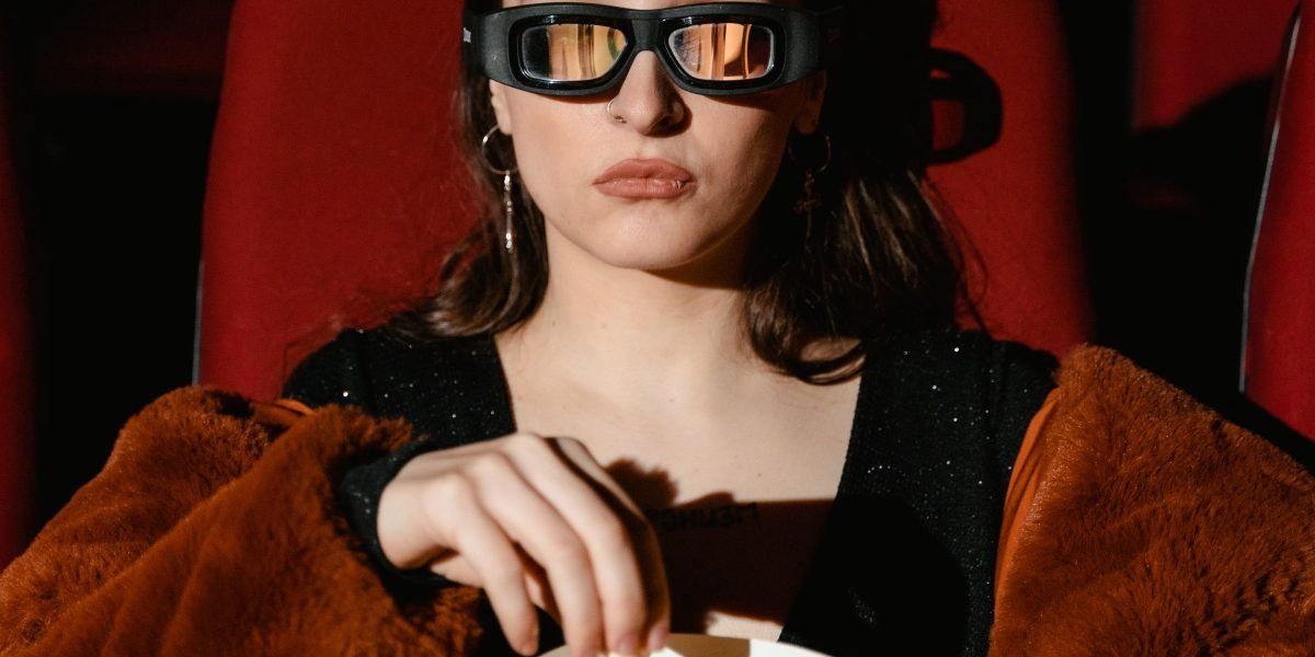 A person confidently selects a movie on a tablet, symbolizing the ease and joy of finding the right film with a good methodology.